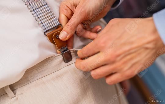 Close-up of hands attaching suspenders to trousers in a menswear shop  : Stock Photo or Stock Video Download rcfotostock photos, images and assets rcfotostock | RC Photo Stock.: