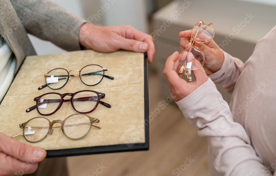 Close-up of hands presenting various eyeglasses on a tray in a o  : Stock Photo or Stock Video Download rcfotostock photos, images and assets rcfotostock | RC Photo Stock.: