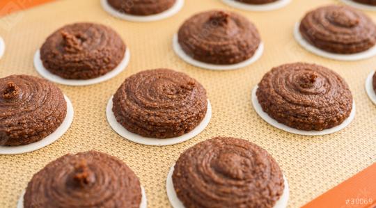 Close-up view of gingerbread dough piped onto wafers, arranged neatly on a silicone baking mat, ready for baking. The texture and swirl pattern of the dough are clearly visible  : Stock Photo or Stock Video Download rcfotostock photos, images and assets rcfotostock | RC Photo Stock.: