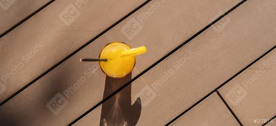 cocktail with orange garnish on a sunny wooden deck, creating a long shadow at a caribbean island hotel  : Stock Photo or Stock Video Download rcfotostock photos, images and assets rcfotostock | RC Photo Stock.: