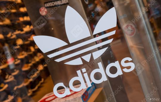COLOGNE, GERMANY OCTOBER, 2017: Adidas logo on a store Window. Adidas Is a German multinational corporation that designs and manufactures sports clothing and accessories.  : Stock Photo or Stock Video Download rcfotostock photos, images and assets rcfotostock | RC Photo Stock.: