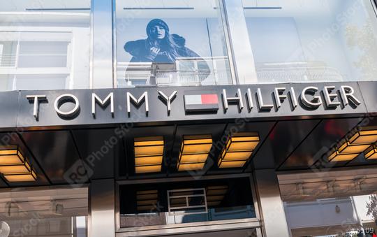 COLOGNE, GERMANY OCTOBER, 2017: Tommy Hilfinger logo on a store. Tommy Hilfiger is a global apparel and retail company founded in 1985 with over 1,400 stores in over 90 countries.  : Stock Photo or Stock Video Download rcfotostock photos, images and assets rcfotostock | RC Photo Stock.: