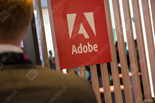 COLOGNE, GERMANY SEPTEMBER, 2017: Adobe Systems Logo with business man. Adobe is a multinational software company that produces and sells multimedia and creativity software.  : Stock Photo or Stock Video Download rcfotostock photos, images and assets rcfotostock | RC Photo Stock.: