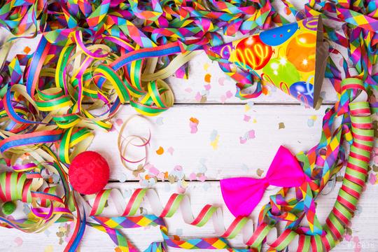 Colorful party decorations including streamers, confetti, a party hat, a red clown nose, and a bright pink bow on a white wooden table, creating a festive and vibrant celebration scene
  : Stock Photo or Stock Video Download rcfotostock photos, images and assets rcfotostock | RC Photo Stock.: