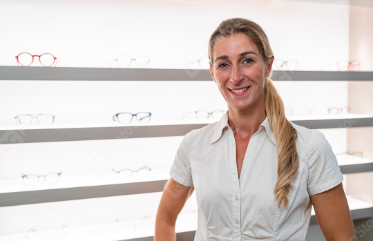 Confident optician in white blouse at eyeglass shop
. Middle-age  : Stock Photo or Stock Video Download rcfotostock photos, images and assets rcfotostock | RC Photo Stock.: