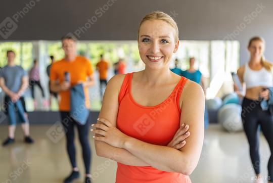 Confident woman in orange tank top standing with arms crossed in a gym. Teamwork Concept image  : Stock Photo or Stock Video Download rcfotostock photos, images and assets rcfotostock | RC Photo Stock.: