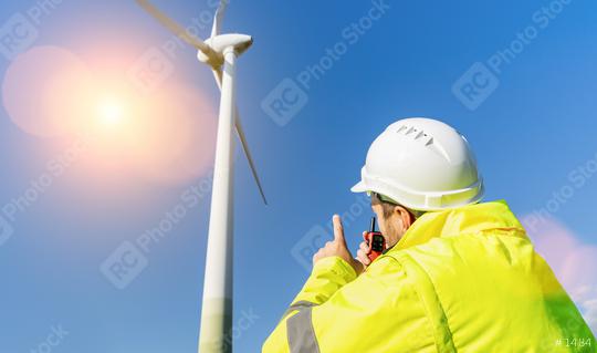 construction worker inspecting wind turbine, speaking with Walkie Talkie  : Stock Photo or Stock Video Download rcfotostock photos, images and assets rcfotostock | RC Photo Stock.: