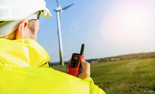 Construction worker with helmet using walkie-talkie to inspecting a wind turbine, copyspace for your individual text.  : Stock Photo or Stock Video Download rcfotostock photos, images and assets rcfotostock | RC Photo Stock.: