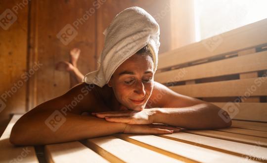 Contented woman lying on a finnish sauna bench with a towel wrapped around her head. Spa wellness hotel concept image.  : Stock Photo or Stock Video Download rcfotostock photos, images and assets rcfotostock | RC Photo Stock.: