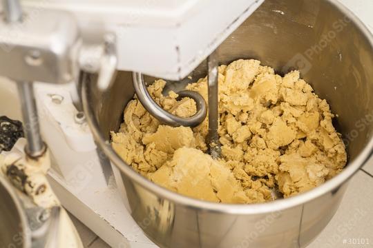 Cookie dough being mixed in an industrial mixer in a bakery, with a dough hook attachment, preparing the dough for baking in a professional baking environment  : Stock Photo or Stock Video Download rcfotostock photos, images and assets rcfotostock | RC Photo Stock.: