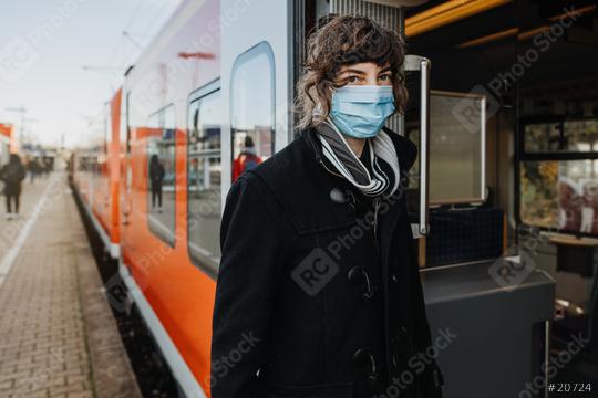 Coronavirus, COVID-19. Young german woman with medical face mask to protect against the coronavirus while waiting for the train on the subway platform. Mouth protection obligation at the train station  : Stock Photo or Stock Video Download rcfotostock photos, images and assets rcfotostock | RC Photo Stock.: