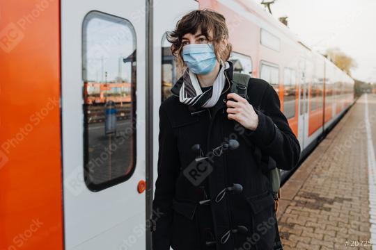 Coronavirus, COVID-19. Young german woman with medical face mask to protect against the coronavirus while waiting for the train on the subway platform. Mouth protection obligation at the train station  : Stock Photo or Stock Video Download rcfotostock photos, images and assets rcfotostock | RC-Photo-Stock.: