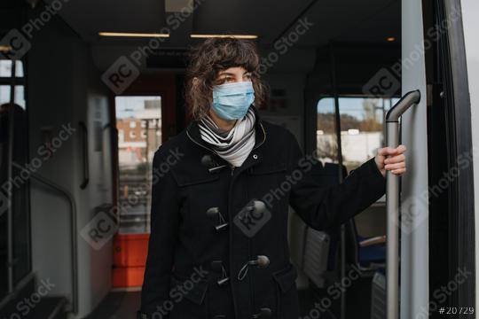 Coronavirus, COVID-19. Young modern woman with medical face mask to protect against the coronavirus while getting in the train on the subway platform. Mouth protection at the train station.  : Stock Photo or Stock Video Download rcfotostock photos, images and assets rcfotostock | RC-Photo-Stock.: