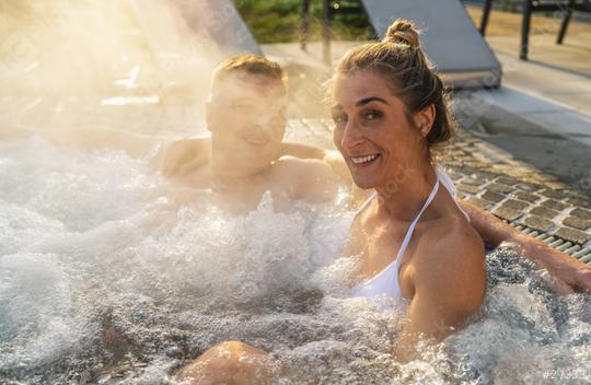 couple enjoying relaxing time in hot tub water outside on vacation  : Stock Photo or Stock Video Download rcfotostock photos, images and assets rcfotostock | RC Photo Stock.: