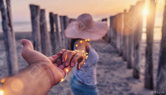 Couple holding hands and walking on beach in sunset, woman with white shirt and shorts jeans  : Stock Photo or Stock Video Download rcfotostock photos, images and assets rcfotostock | RC Photo Stock.: