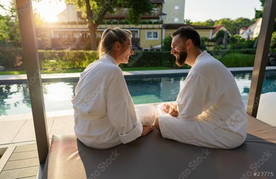 Couple in white bathrobes enjoying sunset by sitting by a pool in a spa wellness hotel  : Stock Photo or Stock Video Download rcfotostock photos, images and assets rcfotostock | RC Photo Stock.: