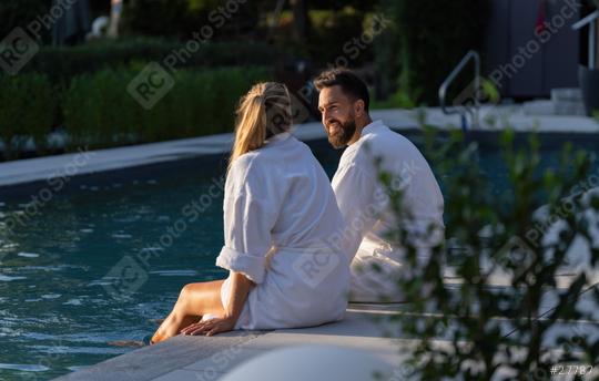 Couple in white robes sitting back to back at the edge of a pool in a spa hotel  : Stock Photo or Stock Video Download rcfotostock photos, images and assets rcfotostock | RC Photo Stock.: