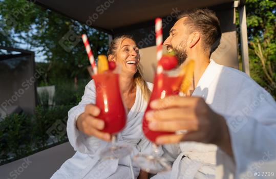 Couple in white robes toasting with red cocktails outdoors at spa resort  : Stock Photo or Stock Video Download rcfotostock photos, images and assets rcfotostock | RC Photo Stock.: