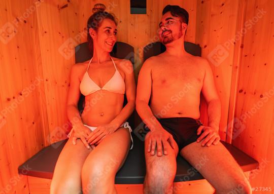 Couple sitting in an infrared sauna, woman in white bikini, man in swim shorts at a spa hotel  : Stock Photo or Stock Video Download rcfotostock photos, images and assets rcfotostock | RC Photo Stock.: