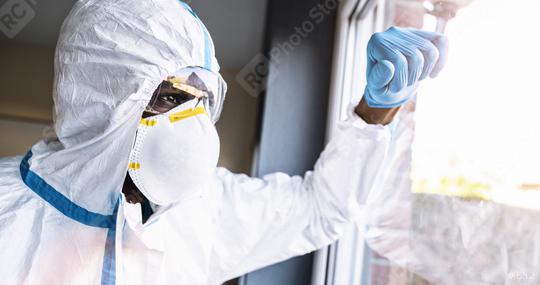 Covid-19 coronavirus epidemic overloads caregiver in protective clothing leans against the window  : Stock Photo or Stock Video Download rcfotostock photos, images and assets rcfotostock | RC Photo Stock.: