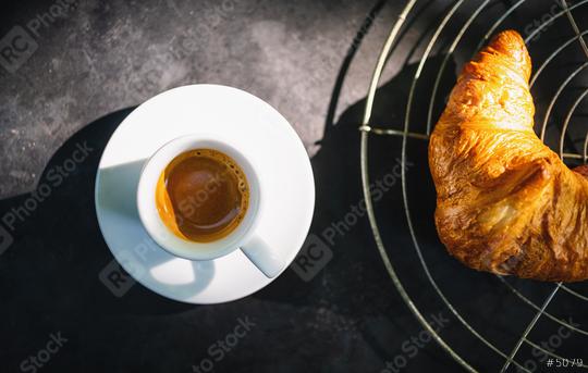 Croissants with espresso. french croissants on bakery grid and cup of espresso coffee on dark concrete background, top view  : Stock Photo or Stock Video Download rcfotostock photos, images and assets rcfotostock | RC Photo Stock.: