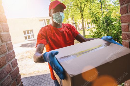 Delivery man employee in red cap blank t-shirt uniform face mask gloves hold empty cardboard box. Service quarantine pandemic coronavirus virus 2019-ncov concept image  : Stock Photo or Stock Video Download rcfotostock photos, images and assets rcfotostock | RC Photo Stock.: