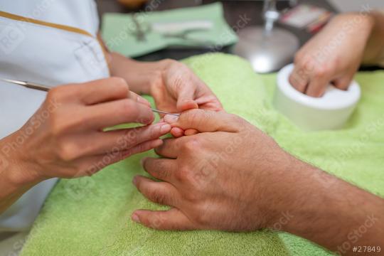 Detailed view of a manicure with a cuticle pusher being used on a fingernails of a male client  : Stock Photo or Stock Video Download rcfotostock photos, images and assets rcfotostock | RC Photo Stock.: