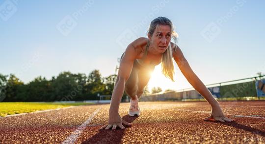 Determined female athlete in starting position on running track  : Stock Photo or Stock Video Download rcfotostock photos, images and assets rcfotostock | RC Photo Stock.: