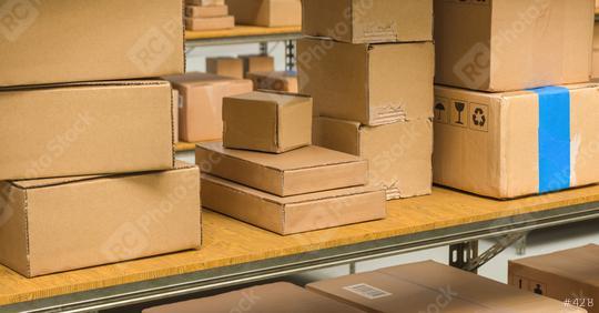 different cardboard boxes on shelves in a warehouse, Packed courier delivery concept image  : Stock Photo or Stock Video Download rcfotostock photos, images and assets rcfotostock | RC-Photo-Stock.: