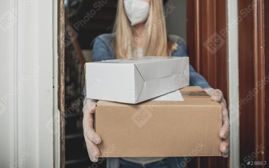 Dispatch postman bring parcels and post in covid 19 quarantine to the front home door with a face mask ffp2 and protection gloves  : Stock Photo or Stock Video Download rcfotostock photos, images and assets rcfotostock | RC Photo Stock.: