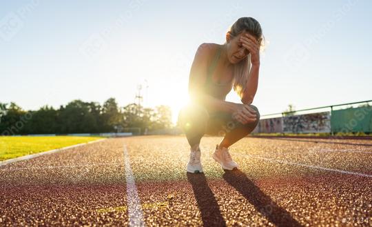 Distressed female athlete resting on a running track  : Stock Photo or Stock Video Download rcfotostock photos, images and assets rcfotostock | RC Photo Stock.: