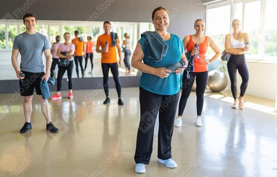 Diverse group of gym-goers with fitness gear in a bright gym, smiling and ready to workout. Teamwork Concept image  : Stock Photo or Stock Video Download rcfotostock photos, images and assets rcfotostock | RC Photo Stock.: