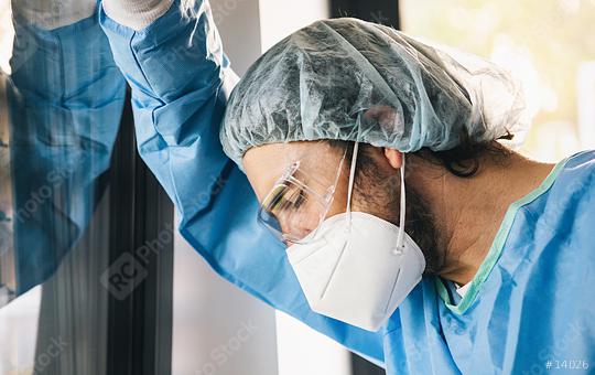 Doctor in protective clothing under stress with burnout during Covid-19 coronavirus epidemic  : Stock Photo or Stock Video Download rcfotostock photos, images and assets rcfotostock | RC-Photo-Stock.: