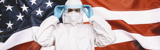 Doctor or Nurse Wearing Medical Personal Protective Equipment (PPE) with protective shield, Against The American Flag Banner. prevent corona COVID-19 and SARS infection concept image, banner size  : Stock Photo or Stock Video Download rcfotostock photos, images and assets rcfotostock | RC Photo Stock.: