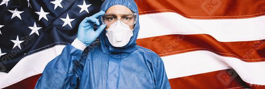Doctor wearing protection Suit for Fighting Covid-19 (Corona virus) SARS infection Protective Equipment (PPE), Against The American Flag Banner. banner size.  : Stock Photo or Stock Video Download rcfotostock photos, images and assets rcfotostock | RC Photo Stock.: