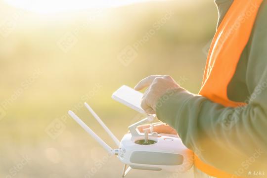 Drone operated by construction worker on building site use touchscreen   : Stock Photo or Stock Video Download rcfotostock photos, images and assets rcfotostock | RC Photo Stock.: