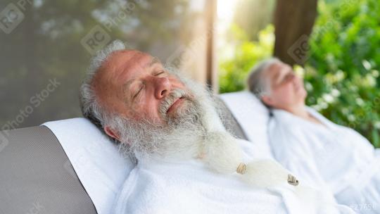 Elderly couple relaxing in white bathrobes on outdoor loungers in a spa wellness hotel  : Stock Photo or Stock Video Download rcfotostock photos, images and assets rcfotostock | RC Photo Stock.: