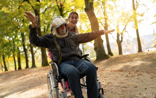 Elderly man in astronaut helmet joyfully extends arms as if flying, with a nurse smiling beside him in an autumn park. Dementia retirement home concept image  : Stock Photo or Stock Video Download rcfotostock photos, images and assets rcfotostock | RC Photo Stock.: