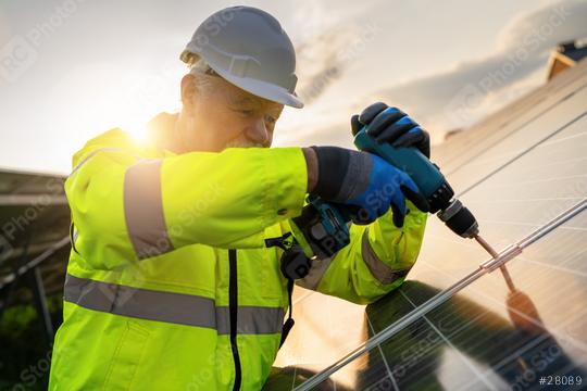 Engineer using a drill for solar panel installation at sunrise. Alternative energy ecological concept image.  : Stock Photo or Stock Video Download rcfotostock photos, images and assets rcfotostock | RC Photo Stock.: