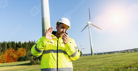 Engineer working a wind turbines, talking on the walkie-talkie for controlling work  : Stock Photo or Stock Video Download rcfotostock photos, images and assets rcfotostock | RC Photo Stock.:
