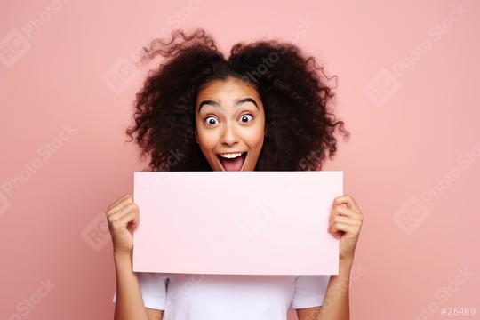 Excited curly-haired woman holding a pink blank sign  : Stock Photo or Stock Video Download rcfotostock photos, images and assets rcfotostock | RC Photo Stock.: