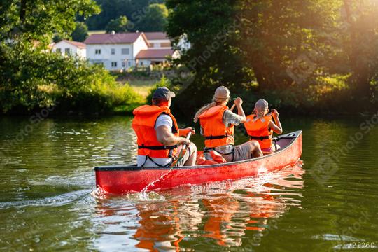 Family in life jackets canoeing on a serene river with vibrant greenery and a sunlit background at summer in germany. Family on kayak ride. Wild nature and water fun on summer Vacation.  : Stock Photo or Stock Video Download rcfotostock photos, images and assets rcfotostock | RC Photo Stock.: