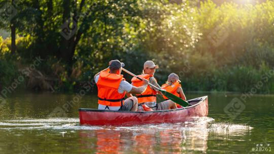 Family in life jackets enjoying a canoe ride on a river, surrounded by lush greenery and sparkling water. Family on kayak ride. Wild nature and water fun on summer Vacation.  : Stock Photo or Stock Video Download rcfotostock photos, images and assets rcfotostock | RC Photo Stock.: