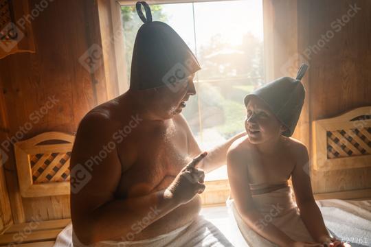 Father and daughter in finnish sauna, wearing felt hats, father talking and daughter listening.  : Stock Photo or Stock Video Download rcfotostock photos, images and assets rcfotostock | RC Photo Stock.: