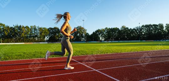 Female athlete running on a sunny track field  : Stock Photo or Stock Video Download rcfotostock photos, images and assets rcfotostock | RC Photo Stock.: