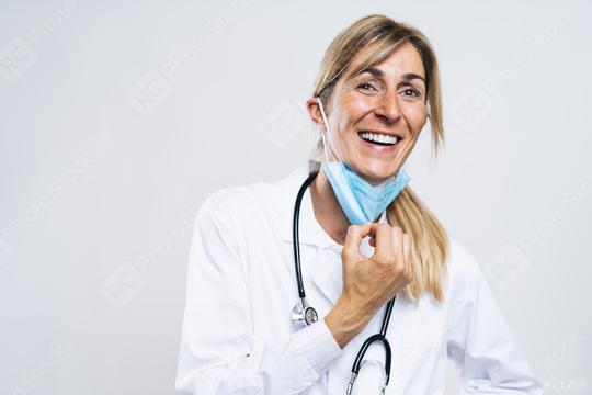 Female Doctor takes off N95 FFP2 an anti virus protection mask and is happy about it after corona COVID-19 and SARS cov 2 pandemic  : Stock Photo or Stock Video Download rcfotostock photos, images and assets rcfotostock | RC Photo Stock.: