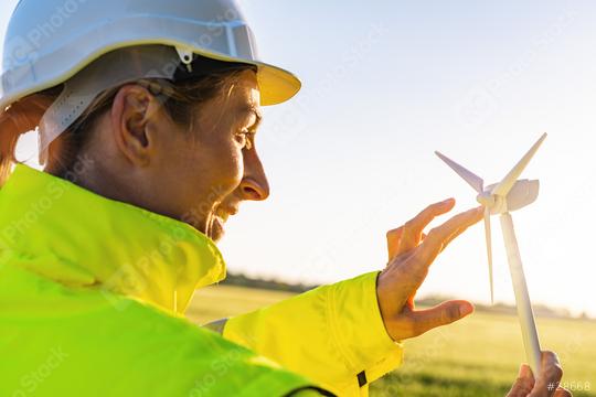 female engineer holding wind turbine model and play with propellers at sunset  : Stock Photo or Stock Video Download rcfotostock photos, images and assets rcfotostock | RC Photo Stock.: