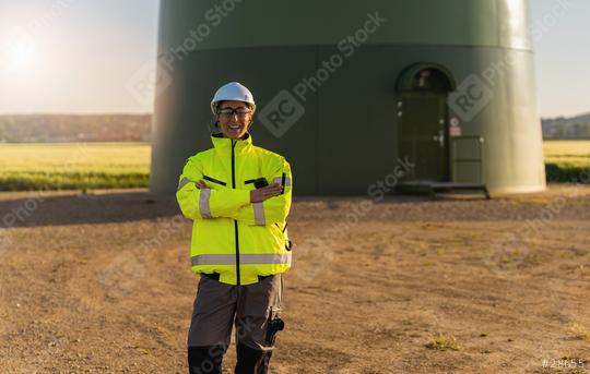 female engineer with safety jacket standing in front of a wind turbine at a new energy farm. regenerative energy concept image  : Stock Photo or Stock Video Download rcfotostock photos, images and assets rcfotostock | RC Photo Stock.: