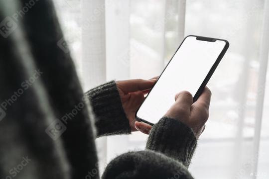 Female hand holding black cellphone with white screen at home against a window, copyspace for your individual text.  : Stock Photo or Stock Video Download rcfotostock photos, images and assets rcfotostock | RC Photo Stock.: