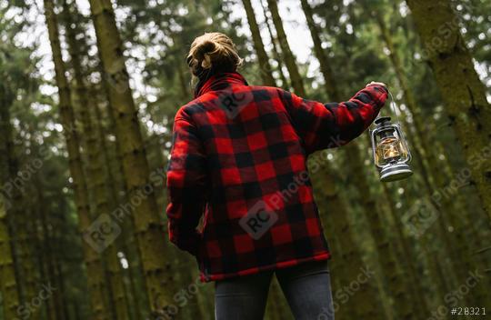 Female Hiker holding a oil lantern or kerosene lamp and walking in the dark forest  : Stock Photo or Stock Video Download rcfotostock photos, images and assets rcfotostock | RC Photo Stock.: